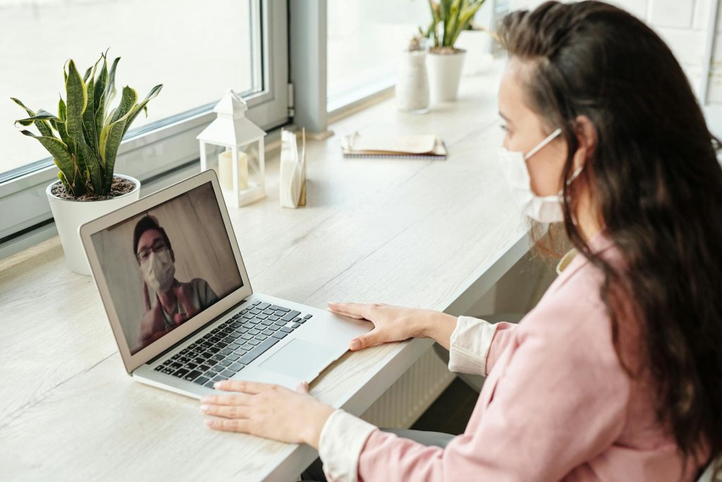 woman seated at a desk focused on her laptop