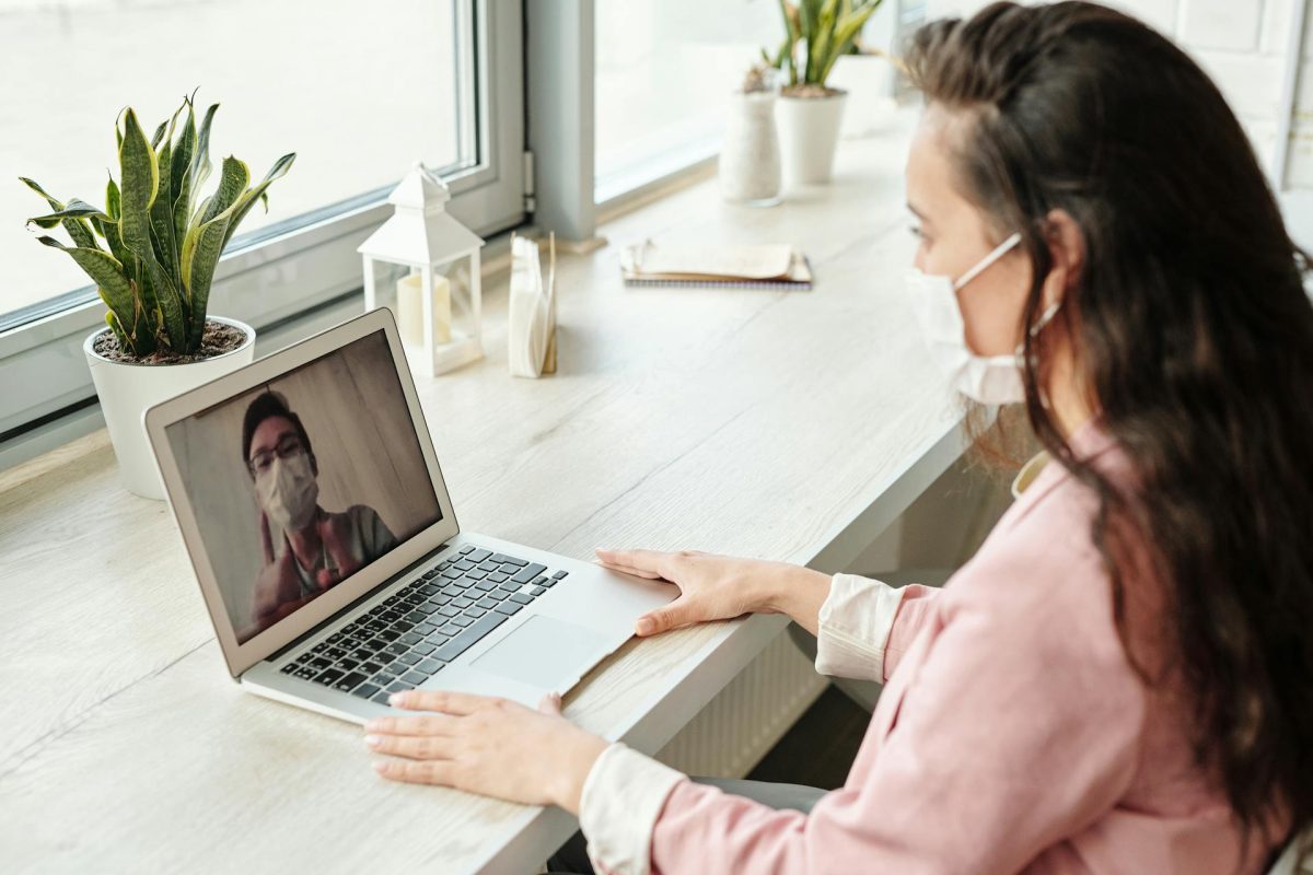 woman seated at a desk focused on her laptop