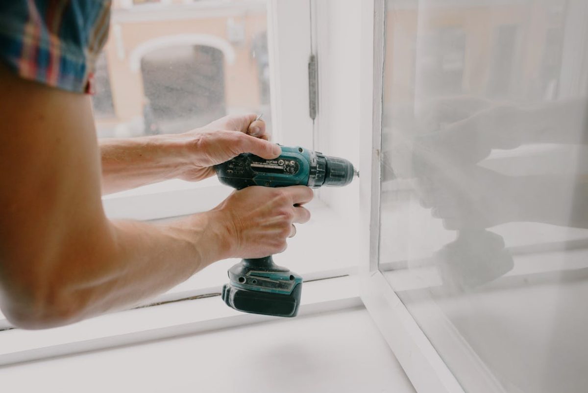 man works on a glass window ensuring proper installation