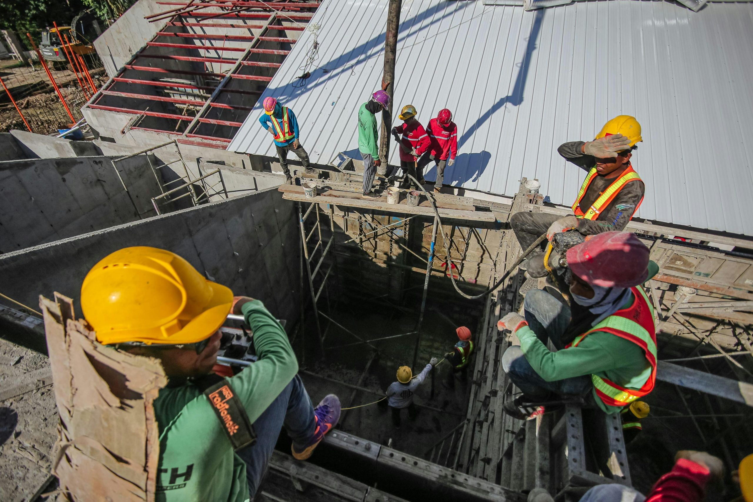 a team of contractors at the top of a building