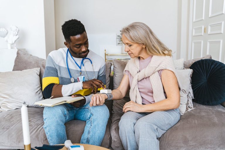 a man and woman relax on a couch, engaged with a tablet