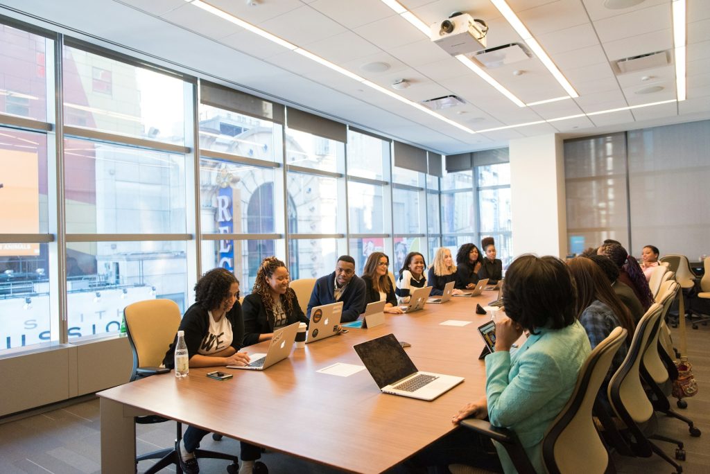 group of professionals engaged in discussion around a large conference table