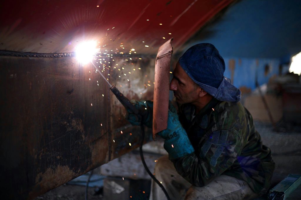 a man engaged in welding inside a workshop