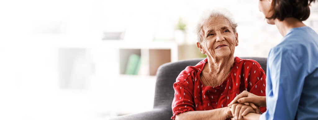 a nurse assisting an elderly woman