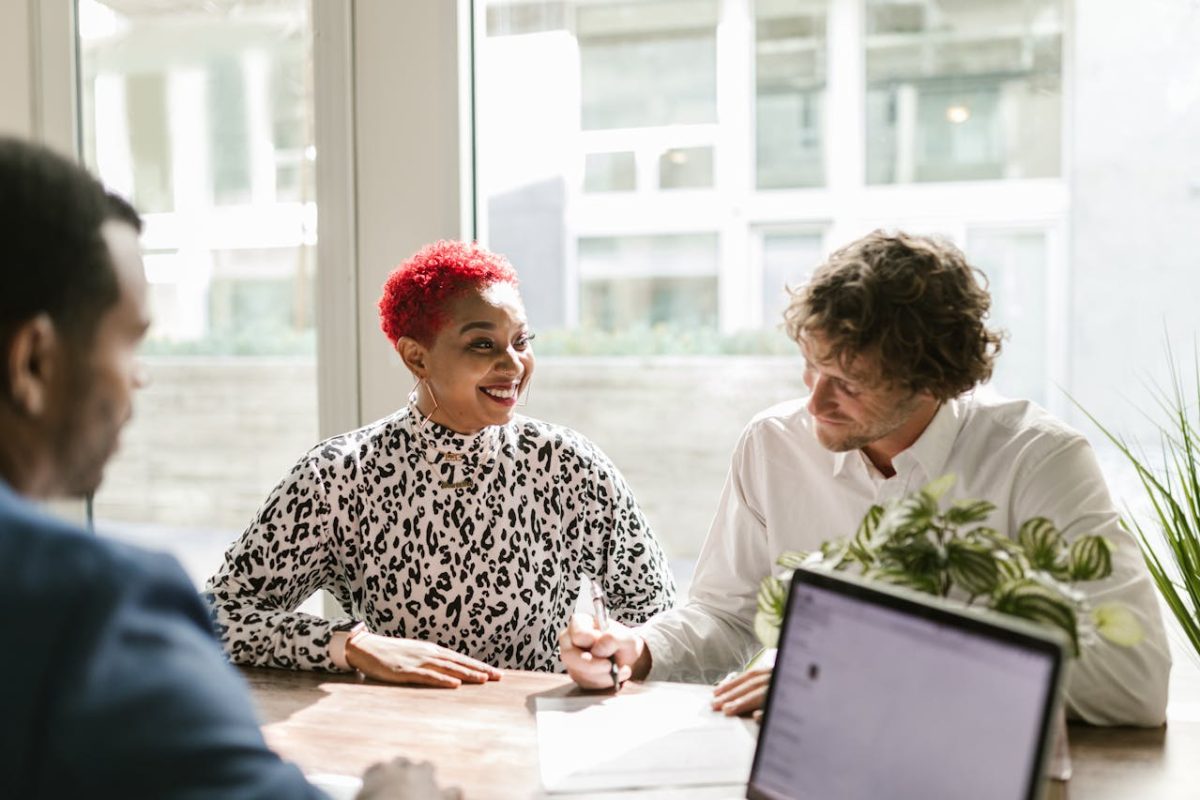 three professionals gathered around a table, discussing insurance matters