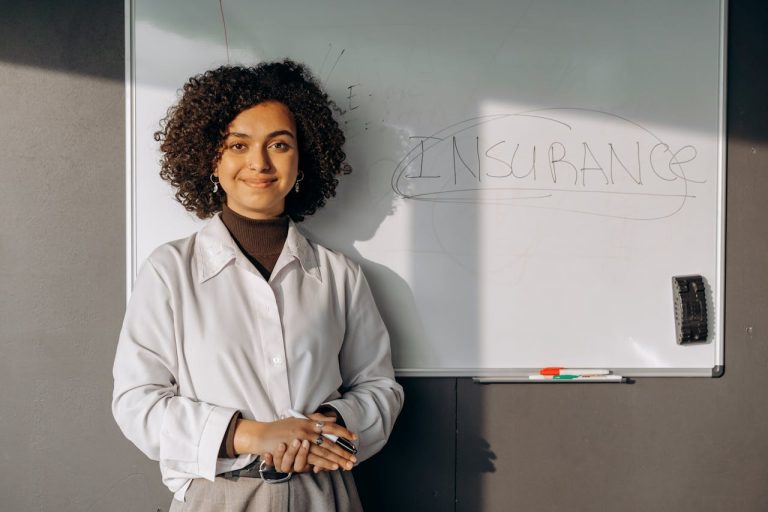 a woman stands before a whiteboard that features the word insurance
