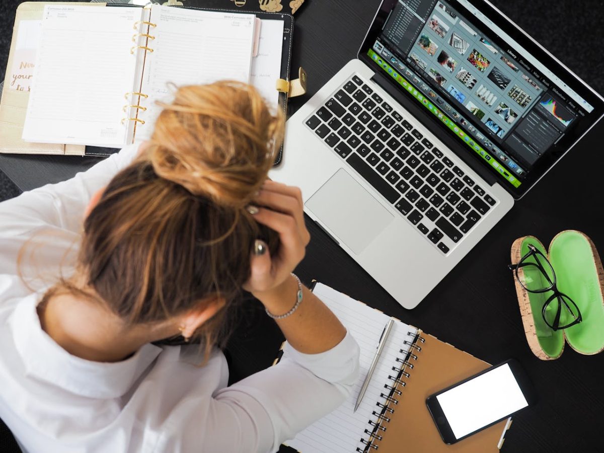 woman at her desk, reflecting on her business insurance policy challenges