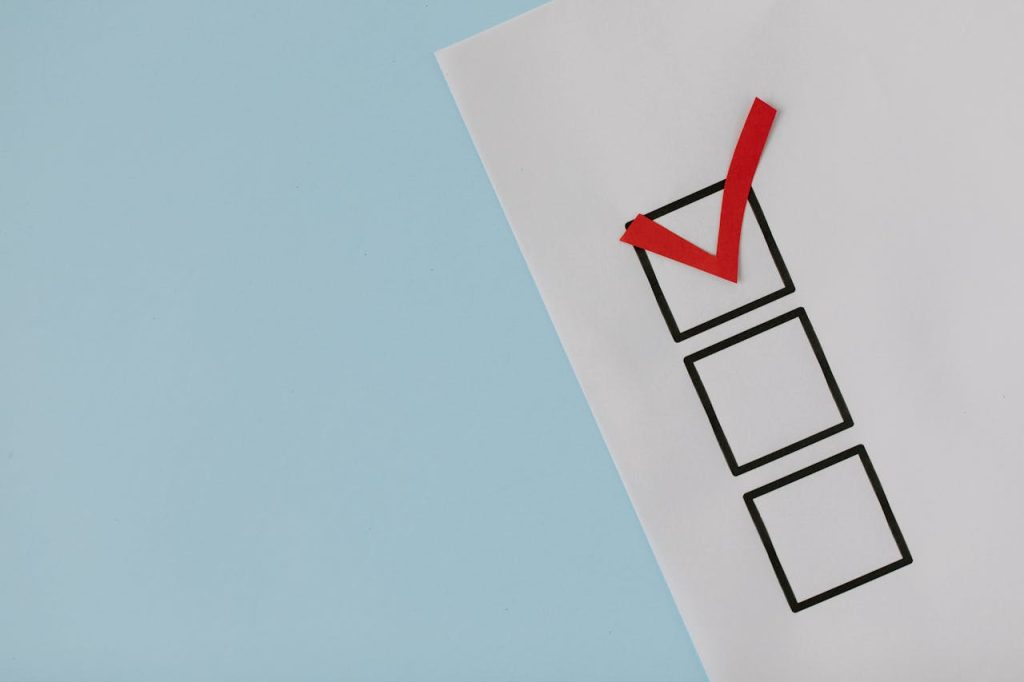 A paper checklist with a red tick mark displayed on a blue background.