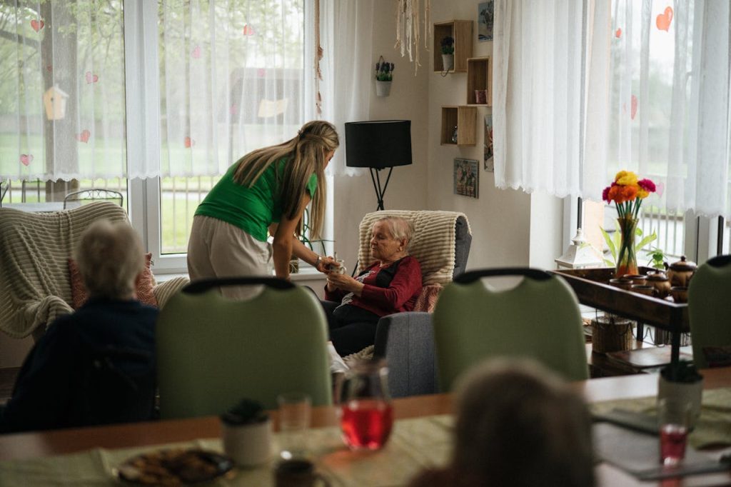 a woman is aiding an elderly woman in a living room