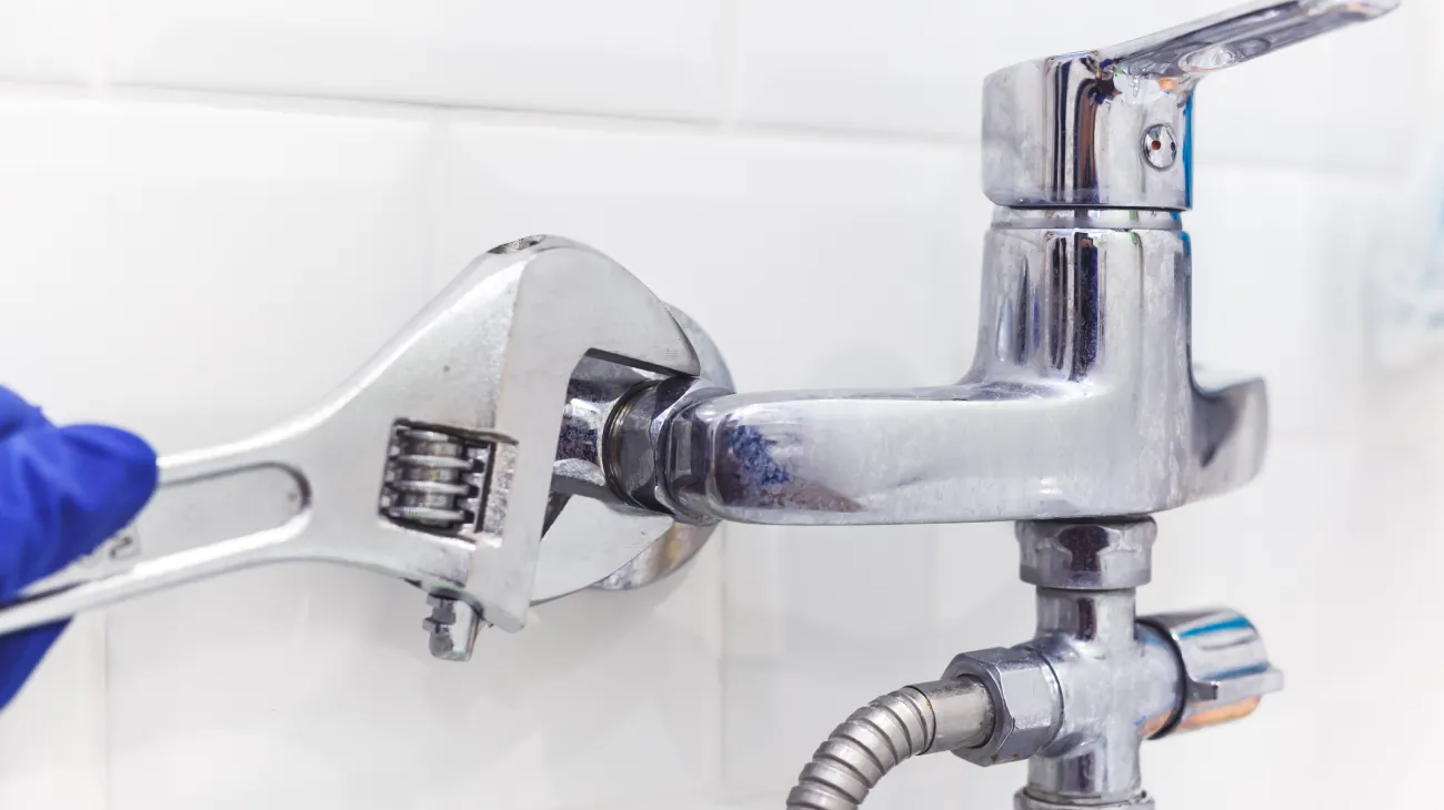Plumber Fixing Faucet